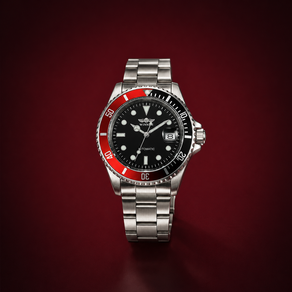 A stainless steel wristwatch with a black dial, a black and red rotating bezel, and a matching metal link bracelet, centered on a dark red gradient background.
